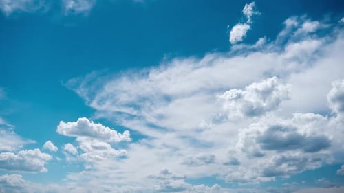 White Clouds Floating in a Vibrant Blue Sky