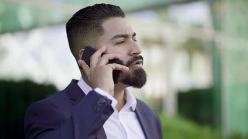 Man in Suit Talking on Smartphone Outside