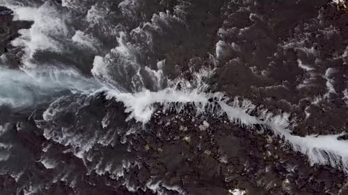 Aerial view of a waterfall in Iceland with snowy beautiful landscape