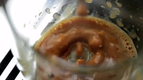 Fresh Coffee Poured into Glass, Close Up