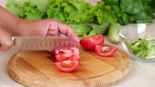 Cutting a Tomato for Salad Preparation