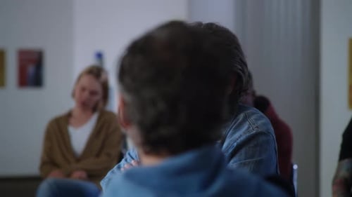 Diverse Adults in Discussion Circle Meeting Indoors