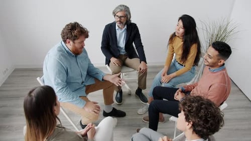 Adults in Group Therapy Session in Bright Room
