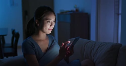 Woman use of tablet at night