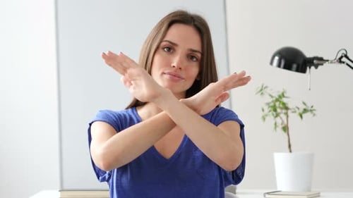 Woman Gestures No with Arms Crossed