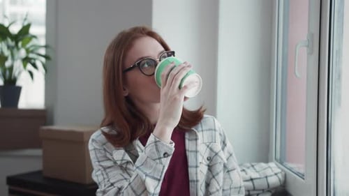 Woman Drinking Coffee by the Window