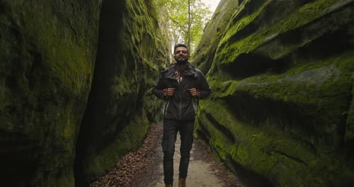 A Man is Walking Down the Gorge and Smiling