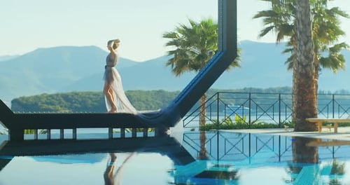 Young lady standing over the pool on holidays. Travel vacation woman relaxing enjoying Montenegro