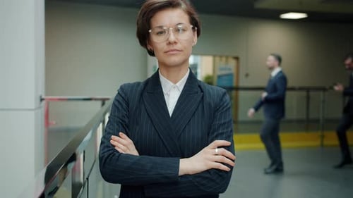 Slow Motion Portrait of Ambitious Young Business Lady Standing in Office Lobby with Serious Face