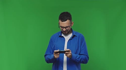 Man Playing Game on Phone, Green Screen