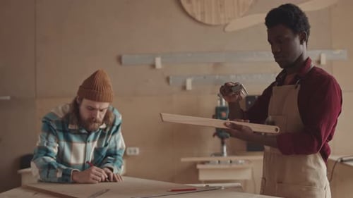 African-American and Caucasian Craftsmen Working in Joinery Workshop