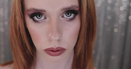 Woman with Dramatic Makeup Looks at Camera
