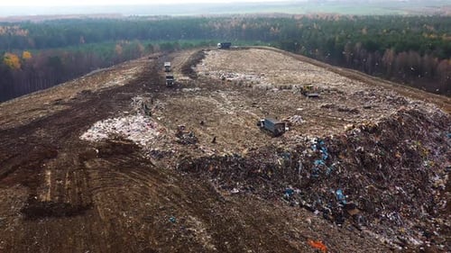 Aerial View of Landfill with Trucks and Bulldozers