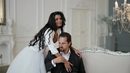 Elegant Couple Embrace in Bright Room