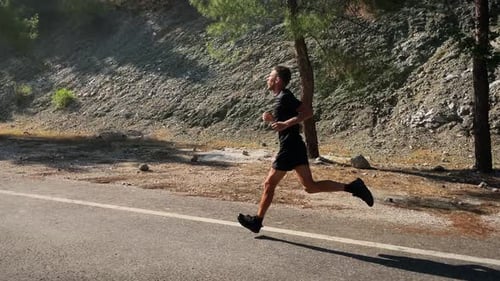 Young Adult Running on a Road in Nature