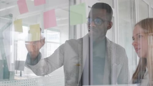 Coworkers Brainstorming Together in Bright Office Space