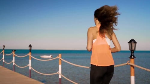 Woman Runs on Pier, Stops to Rest