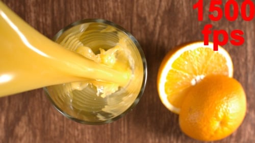 Pouring Fresh Orange Juice into a Glass