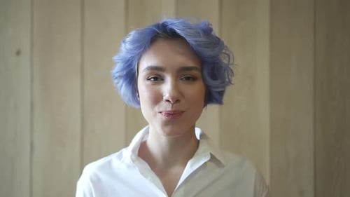 Portrait of a Young Woman with Blue Hair Smiling