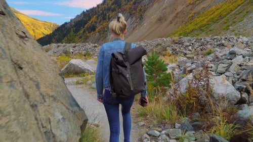 Woman Hiking in the Mountains in Autumn
