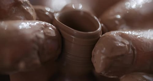 Hands Shaping Clay Pot on Pottery Wheel
