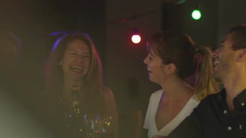 Friends Laughing at Evening Dinner Party