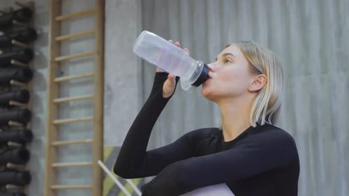 Fit Woman Hydrating During Gym Workout
