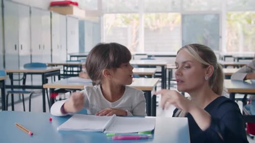 Friendly Female School Teacher Helping Latin Schoolgirl