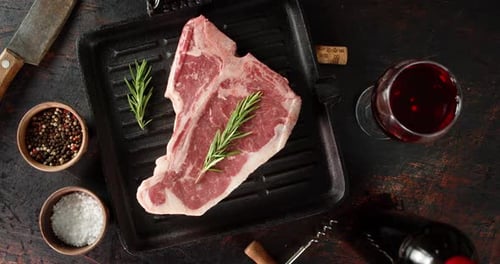 Raw Steak Beef T-bone in a Frying Pan Slowly Rotates.