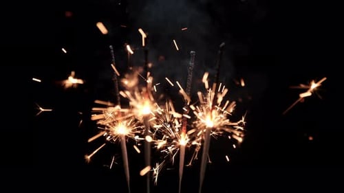Sparkling Sparklers Emitting Golden Sparks in the Dark