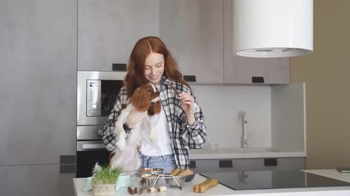 Woman with Dog in Modern Kitchen