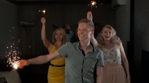 Friends Celebrating with Sparklers at Indoor Party