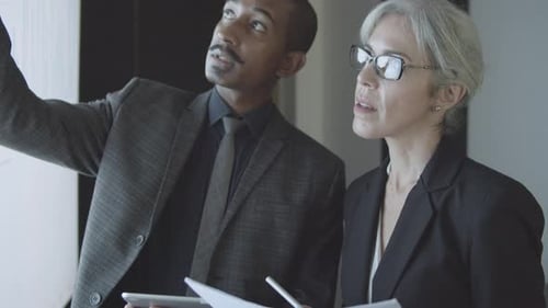 Business Professionals Reviewing Charts and Graphs Together