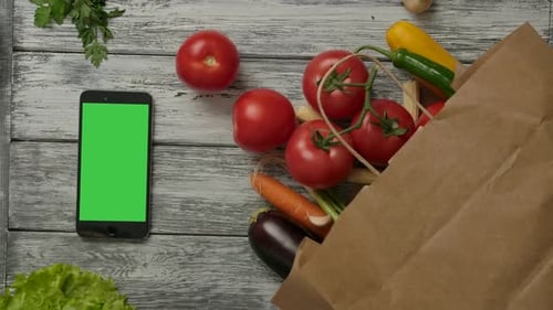 Fresh Vegetables and Smartphone with Green Screen Overhead