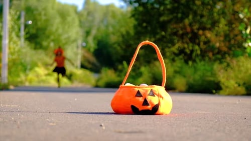 Girl in Witch Costume Running to Halloween Bag