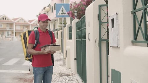 Delivery Man Delivers Package to Woman at Gate