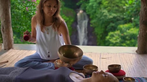 Singing Bowls for Relaxation near Tropical Waterfall