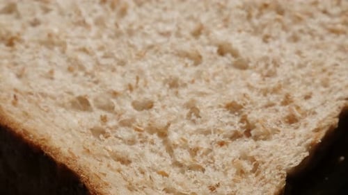 Whole grain toast bread baked surface close-up slow tilt 4K 2160p 30fps UltraHD footage - Texture o