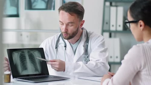 Doctor Explains X-ray to Patient in Office