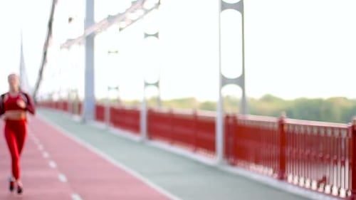 Woman Runs Across Bridge During the Daytime