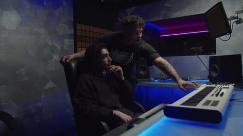 Inspired Diverse Multiethnic Male Hip Hop Artists Recording New Track in Sound Recording Studio