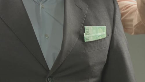 Woman's hand taking euros from husband's jacket pocket, loss of money, closeup