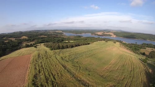 Aerial View of Green Hills and Lake