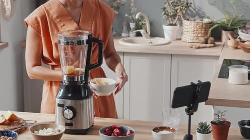 Woman Preparing Healthy Smoothie in Bright Kitchen