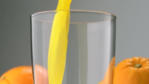 Pouring Fresh Orange Juice into a Glass
