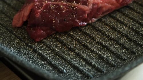 Seasoned Raw Steak On Grill Pan Close Up