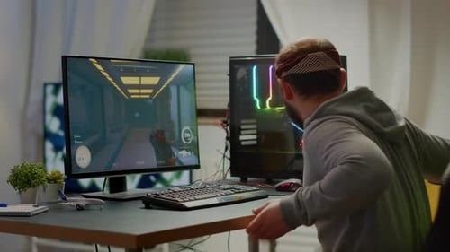 Young Adult Gamer Playing Video Game at Home