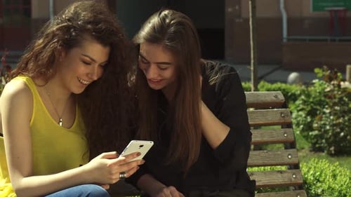 Two Young Women Looking at Phone