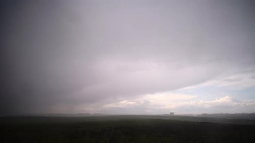 Rain dark clouds in the sky during a storm in a dramatic sky, timelapse
