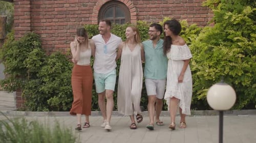 Five Friends Walking Together Down City Street